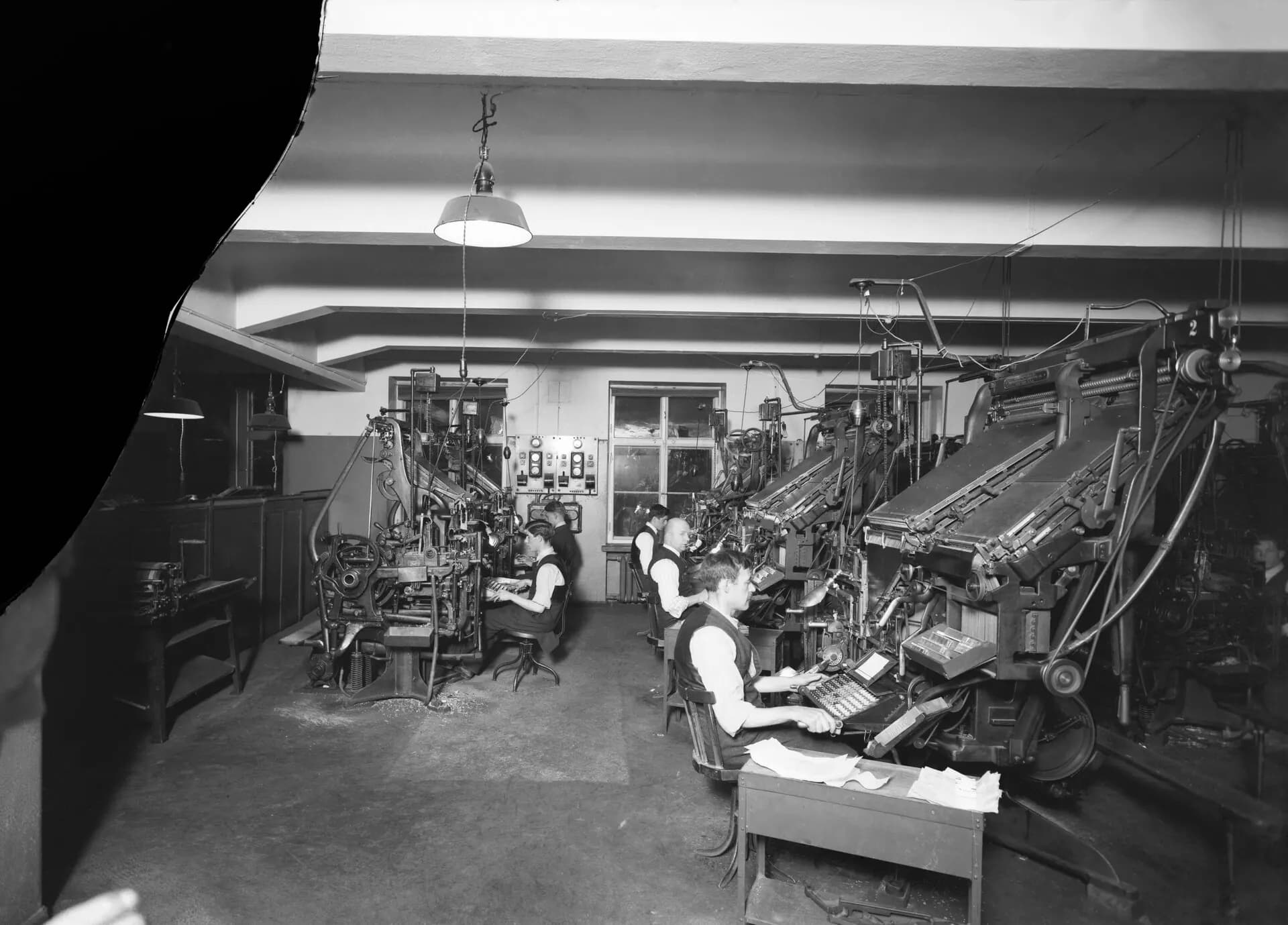 A newspaper composing room in 1927: typesetters at their frames and casting machines