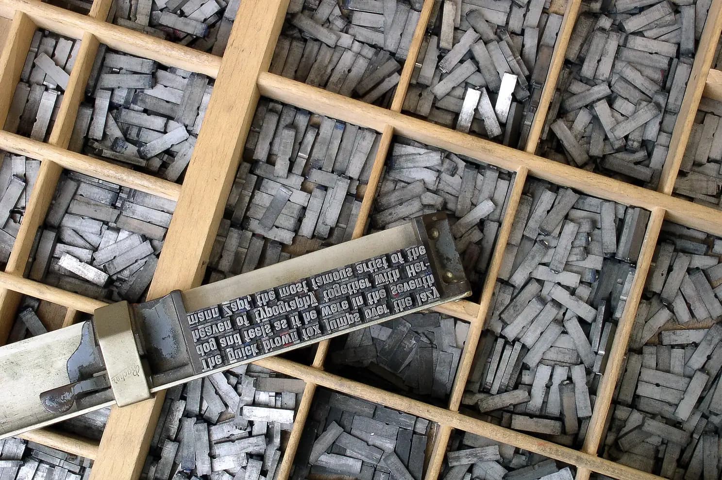 Rows of metal movable type in a letterpress case, each glyph cut in lead
